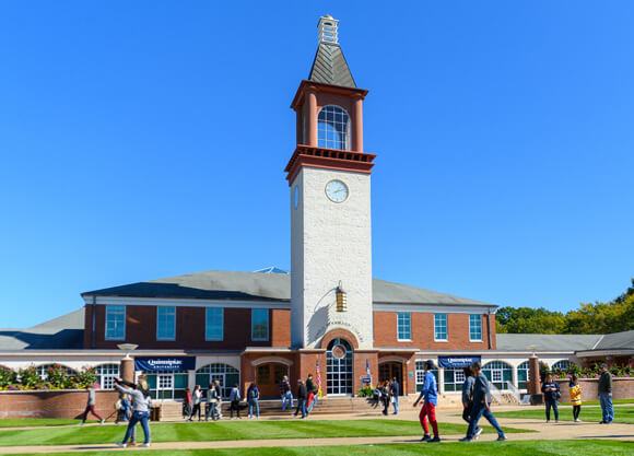 Dozens of people walk around the Mount Carmel Campus Quad